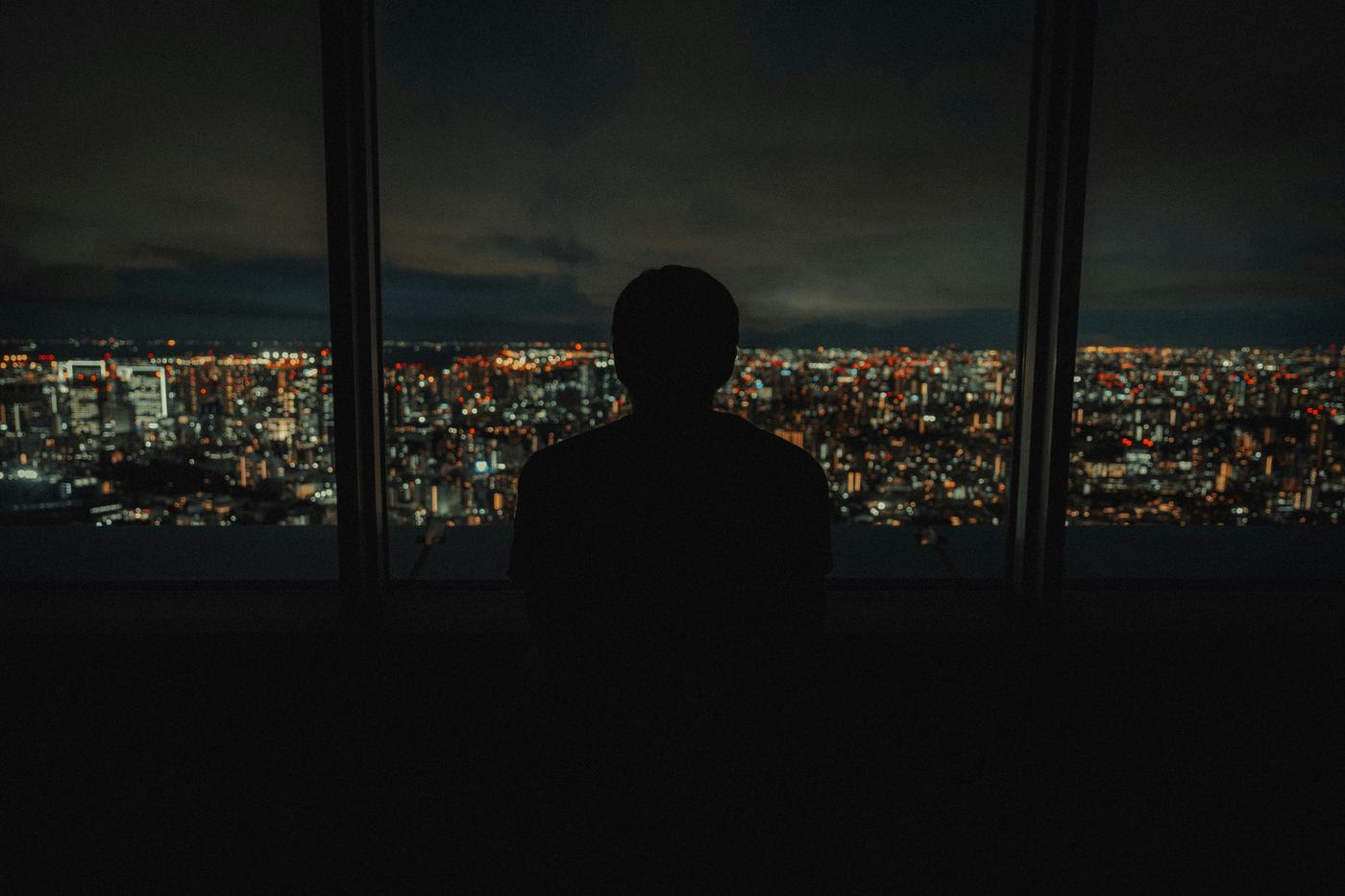 Man looking over city at night